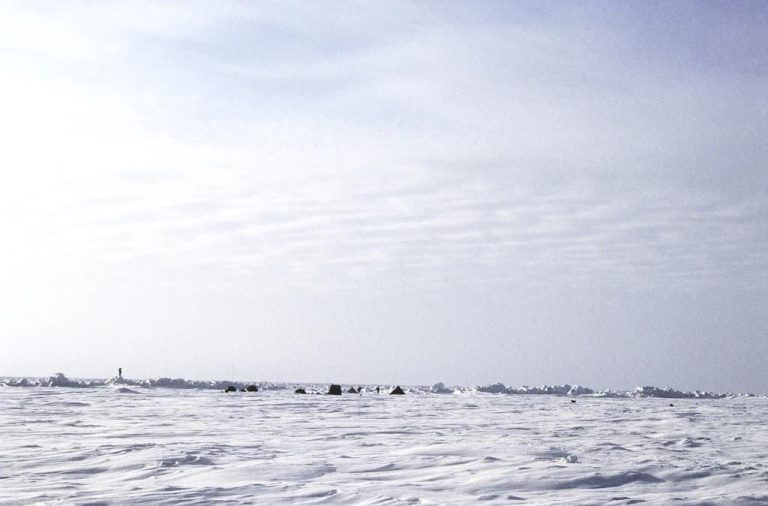 Arctic Ocean Sensors Record a Warmer Deep Current broken arctic sea ice floating on dark ocean water